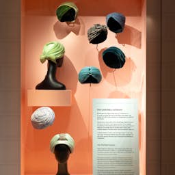 Poster image for the exhibition titled Hatt Couture: Royal Hat Fashion in the Royal Armoury